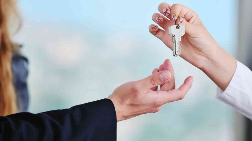 Kansas City Elite Basement Finishing handing keys for home remodeling project