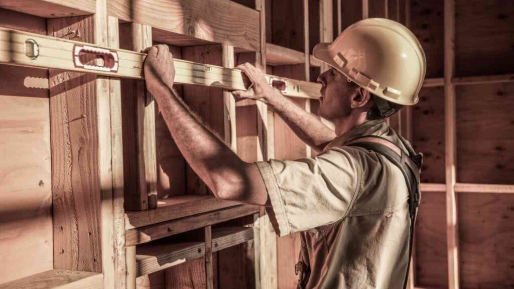 Kansas City Elite Basement Finishing general contractor measuring framing for basement remodeling